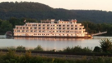 A river boat cruises by on the Misissippi River boat in front of Sullivan's Supper Club in Trempealeau, WI