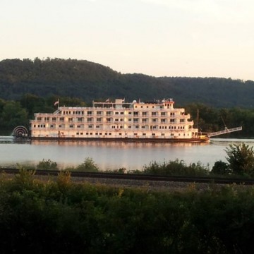 A river boat cruises by on the Misissippi River boat in front of Sullivan's Supper Club in Trempealeau, WI